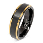 Black tungsten carbide ring with gold inlay on a white background