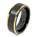 Black tungsten carbide ring with gold edge on a white background