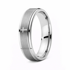 Silver ring with a cross engraving on a white background