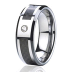 Silver ring with carbon fiber inlay and diamond on a white background